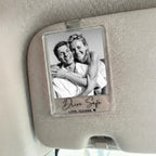 A personalized couple photo car visor clip displaying a black and white photo and custom text mounted on a car sun visor.