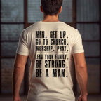 Beige Christian men's graphic t-shirt viewed from the back, featuring distressed black typography print.