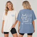 Model wearing an ivory custom oversized t-shirt with blue text and a blue t-shirt showing the back print Last Toast On The