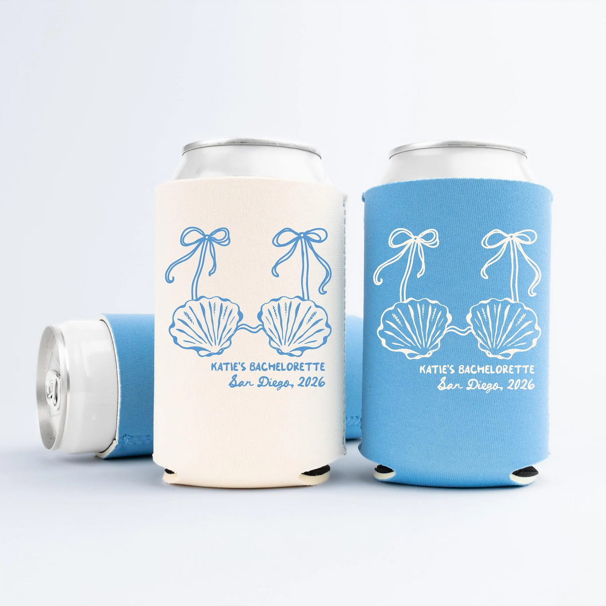 Ivory and sky blue Custom Little Mermaid Bachelorette Can Coolers with shell bikini and ribbon print against plain background