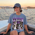 A woman wearing a slate blue custom pet portrait t-shirt on a boat with mountains in the background during sunset.
