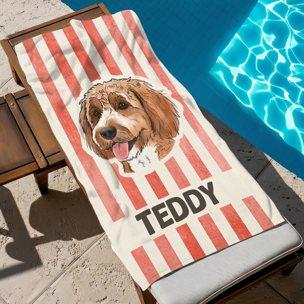 Red striped personalized Doodle dog portrait beach towel resting on a lounge chair beside a sparkling pool.