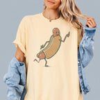 Person wearing ivory cotton Funny Hotdog Graphic T-Shirt with denim jacket draped over shoulder.