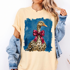 Butter-yellow Leopard Duck With Red Bow Graphic Tee worn with denim jacket in close-up front view.