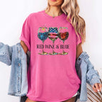 A woman wearing a vibrant pink Red Wine & Blue Graphic T-Shirt with patriotic wine glass graphics and a denim jacket.
