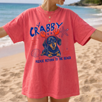 Woman wearing red vintage finish garment-dyed tee with dachshund graphic at the beach