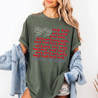 Woman wearing a green cotton graphic t-shirt with American flag print and denim jacket