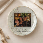 Round glazed porcelain ceramic jewelry trinket dish with gold-trimmed edge featuring a custom photo of two women and text.