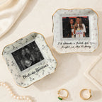 Two wavy square ceramic ring dishes with floral borders, custom photos, and best friend text on a textured neutral tabletop.