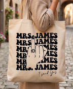 Woman wearing beige holding cotton canvas tote bag with black Mrs print on street
