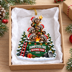 Personalized dumpster fire raccoon ornament resting inside an open gift box lined with white tissue paper.