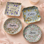Four personalized floral ceramic trinket dishes in round, square, and wavy shapes with gold rims and custom names.