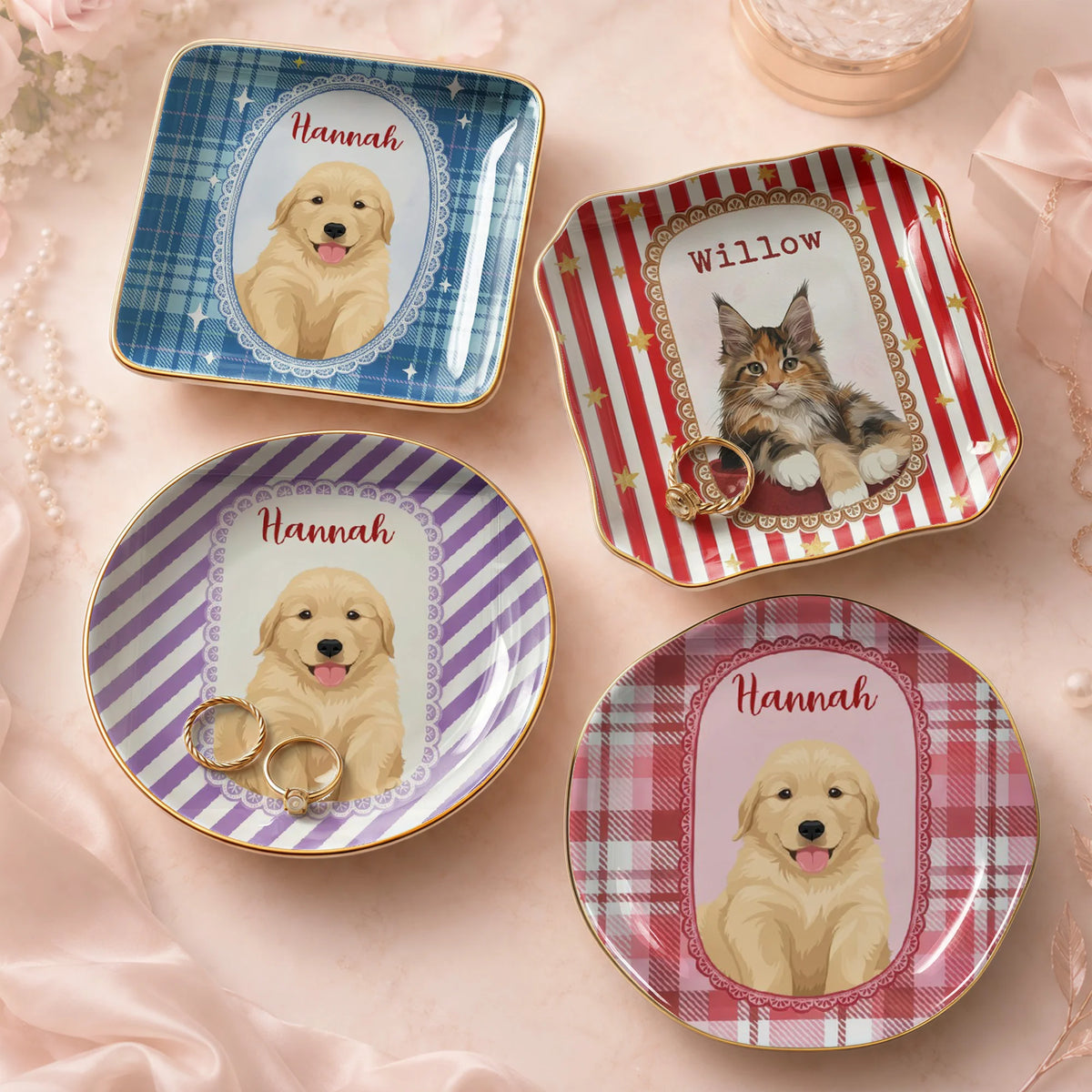 A collection of customized dog and cat trinket trays arranged on a neutral fabric background with gold jewelry.
