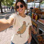 Smiling woman taking selfie at street hot dog stand wearing ivory retro foodie shirt featuring funny cartoon graphic.
