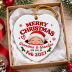 Heart-shaped ceramic ornament inside an open gift box with white tissue paper, featuring a baby graphic and custom