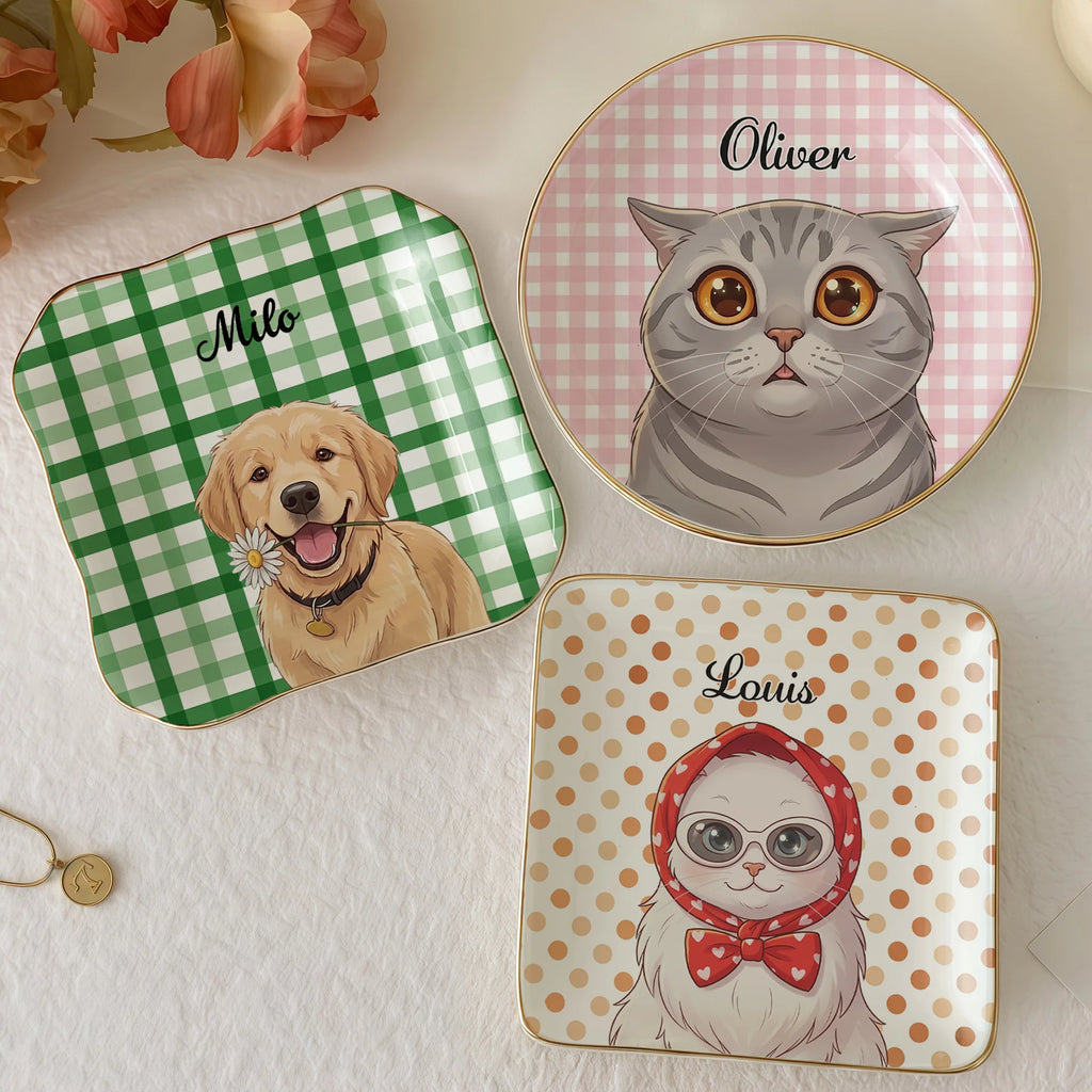 Three ceramic display plates featuring a green gingham golden retriever, pink gingham cat, and orange polka dot cat.