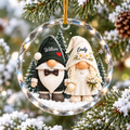 Personalized gnome wedding couple ornament hanging on a snowy Christmas tree branch with customized names William and Emily.