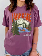 Vintage purple t-shirt featuring retro nature mountain and river graphic with custom text.