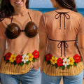 Two people wearing fake coconut bikini graphic tees with grass skirts and flower leis, standing near the ocean.