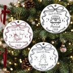 Three round white ceramic ornaments with custom wedding line art hanging on a Christmas tree with glowing lights and