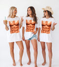 Three smiling women wearing oversized white six pack abs graphic t-shirts and denim shorts in a group bachelorette party