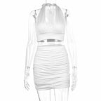 White ruched halter crop top and matching mini skirt displayed on a clear transparent mannequin.