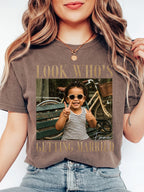 A person wearing a charcoal custom photo t-shirt with a childhood picture print and bride engagement theme.
