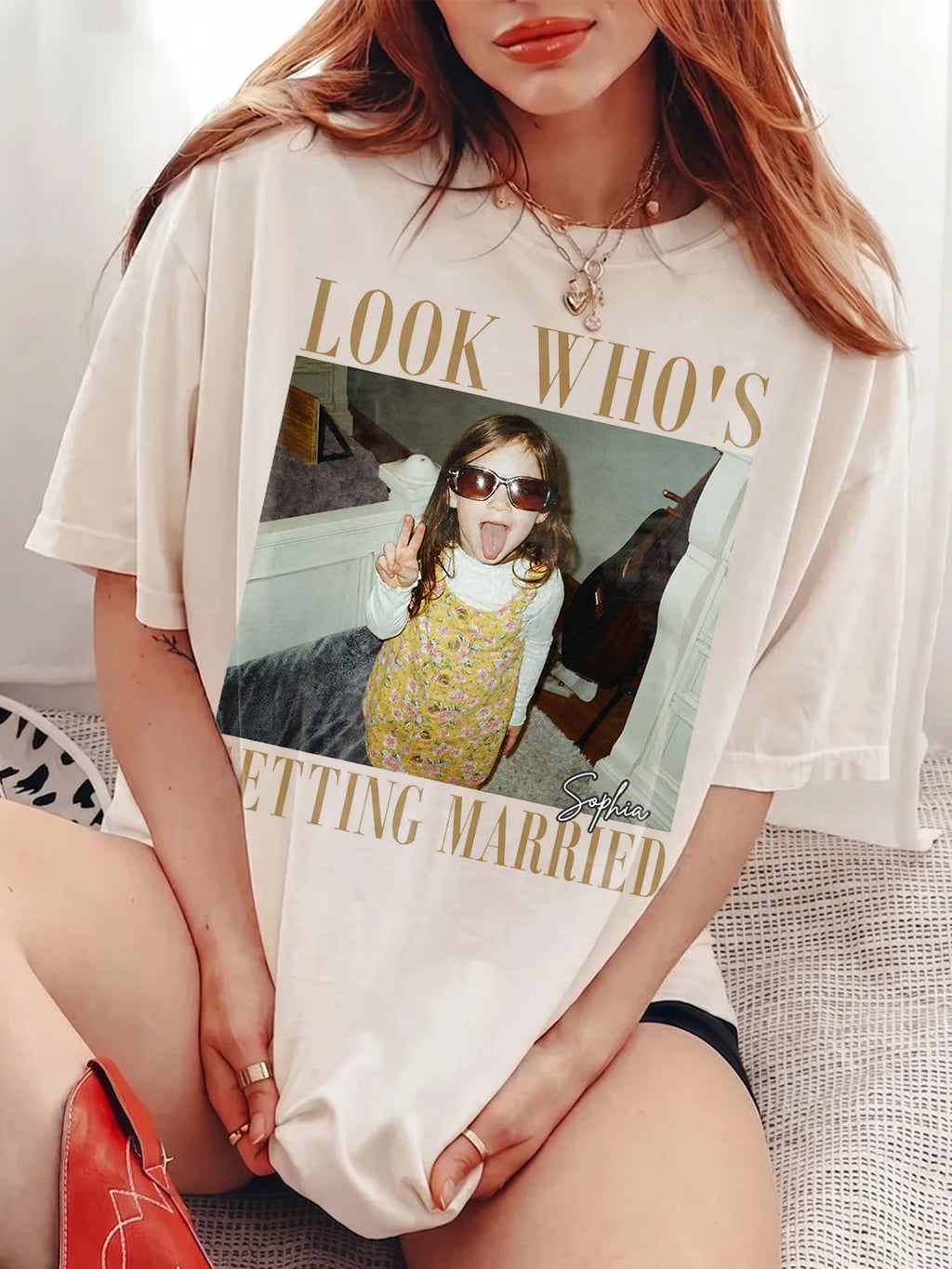 A woman wearing an ivory Getting Married Custom Photo T-Shirt featuring a childhood photo, gold serif text, and name.