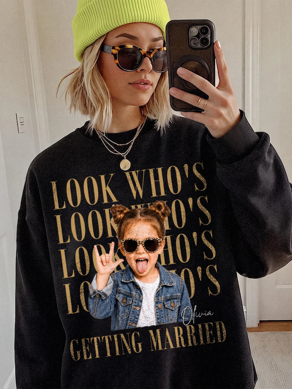 A person wearing a black custom photo sweatshirt with retro stacked typography and a child photo cutout in the center.