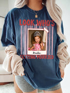 Woman wearing dark blue custom photo shirt with arched red lettering and childhood memory polaroid graphic.