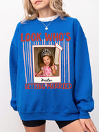 Woman wearing bright blue graphic T-shirt with personalized polaroid photo and Look Who's Getting Married design.