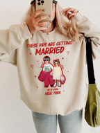 Woman taking mirror selfie in beige custom photo sweatshirt featuring childhood couple picture and bold red vintage text.