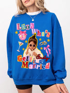 A person in a bright blue custom engagement gift sweatshirt showcasing a colorful retro collage design with a child in