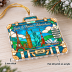 Close-up of the vintage suitcase travel ornament lying on a wooden surface showing its 3mm thickness and flat 2D acrylic